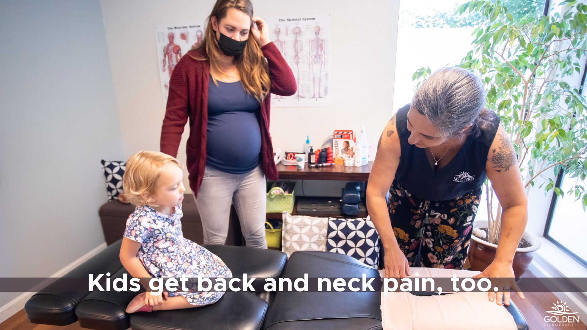 Dr Goldi, a young toddler and a pregnant woman inside the treatment room 