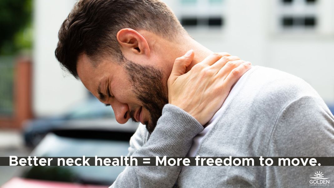 man clutching his neck in pain