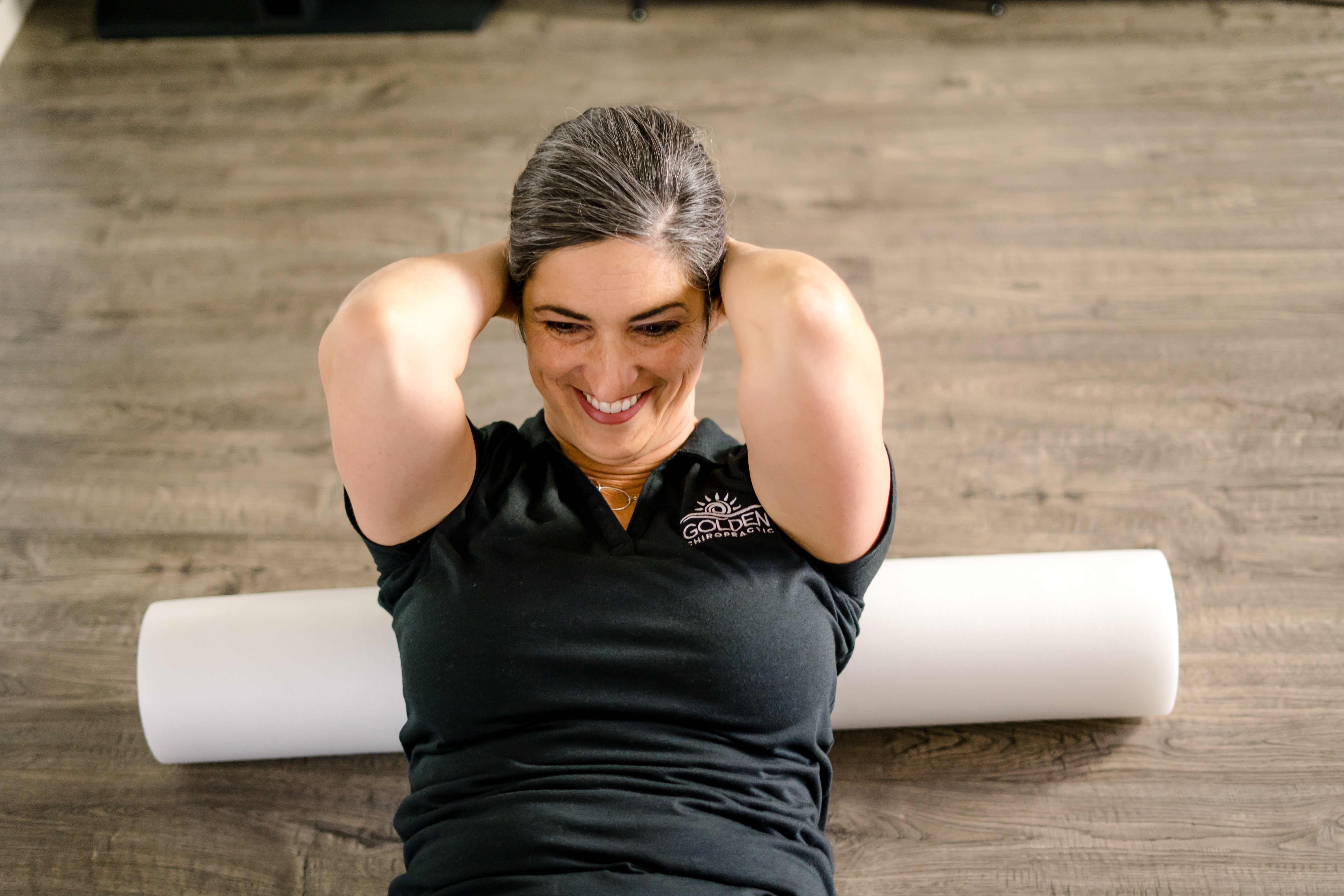 Dr Goldi demonstrates an exercise for neck and upper back pain using a foam roller