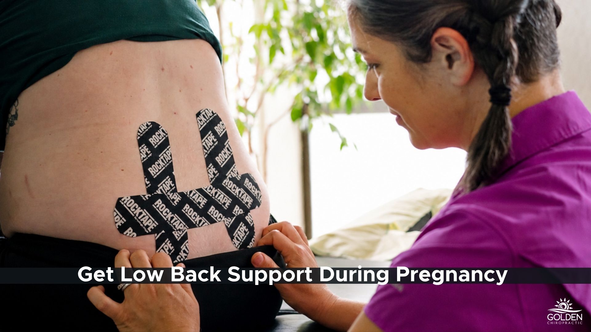 Dr. Goldi applying RockTape to a pregnant patient's low back