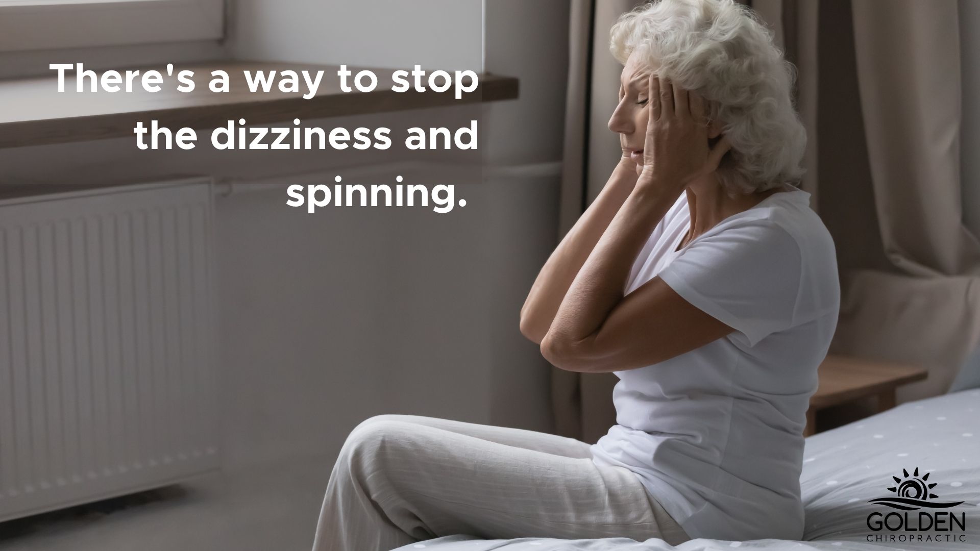 Older woman sitting on her bed clutching her temples while looking overwhelmed