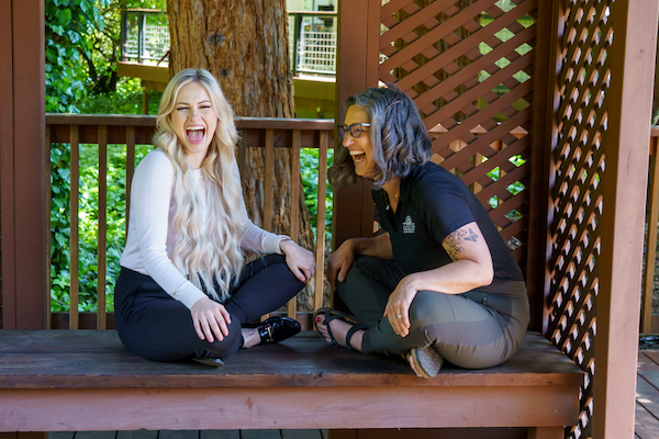 Dr goldi and dr michaela sitting and laughing