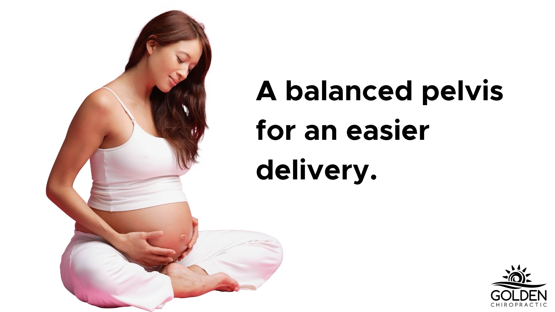 Pregnant woman sitting on floor meditatively holding her belly