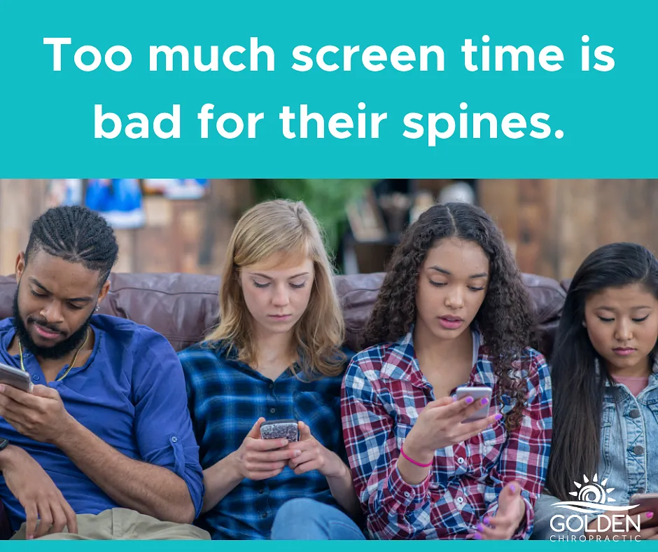 one teen boy and three teen girls hunched over their smartphones