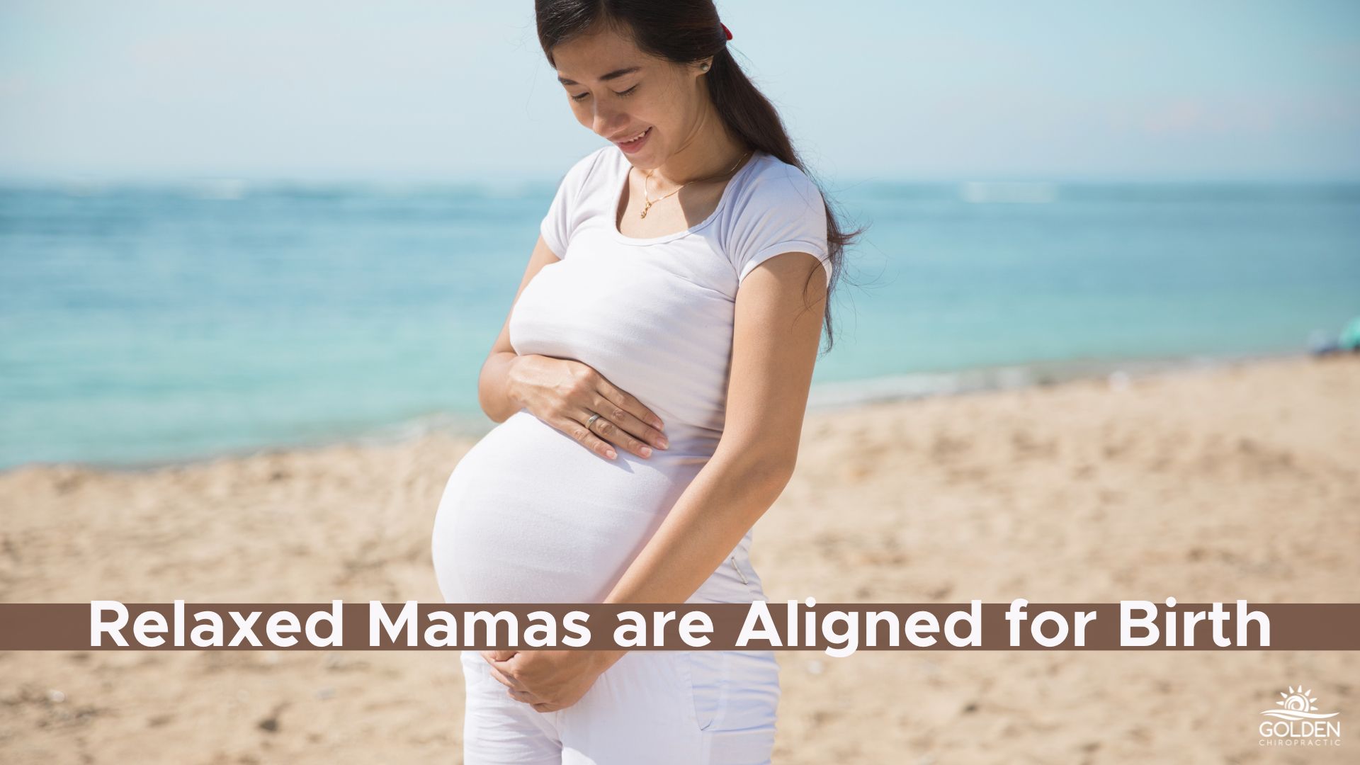 Smiling pregnant woman on beach