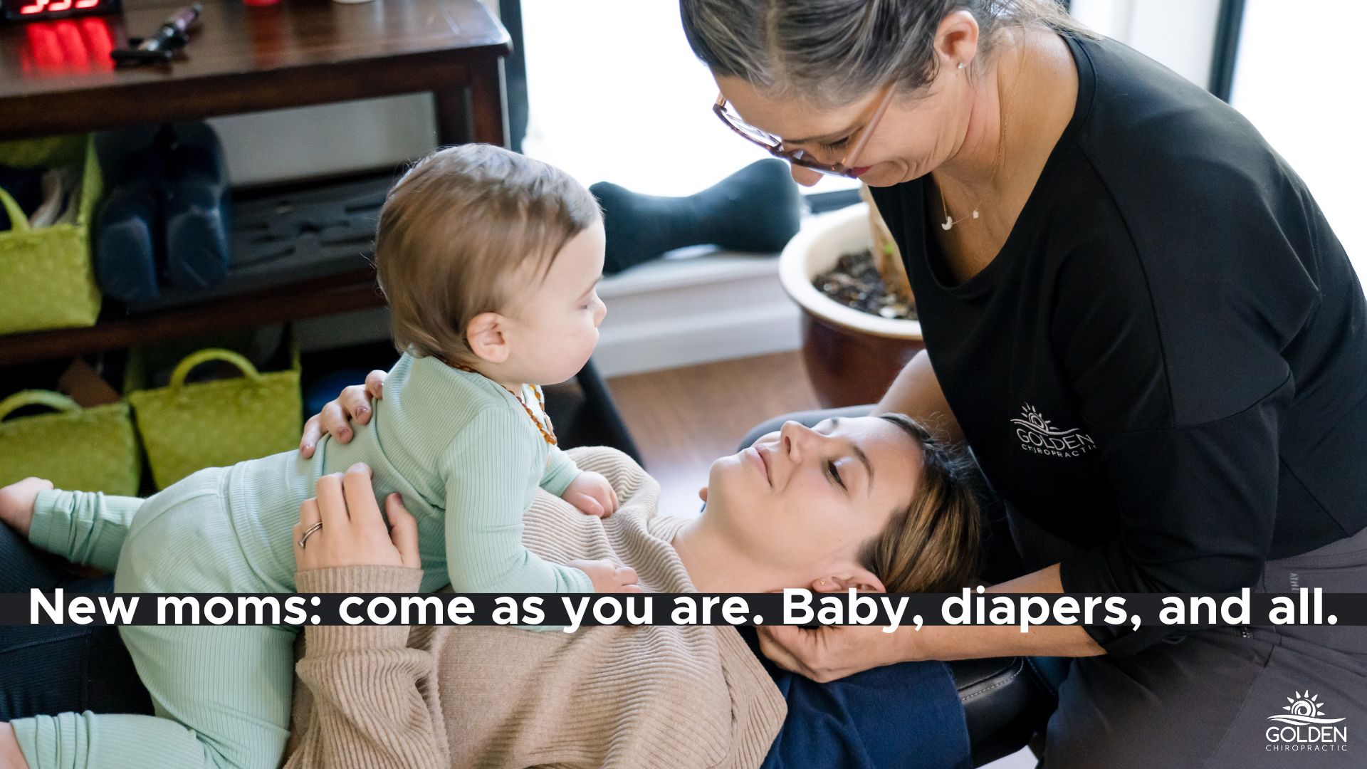 Dr. Goldi adjusting the neck of a new mom as mom holds her baby at Golden Chiropractic in Aptos