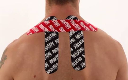 Man with RockTape H pattern on his neck and upper back