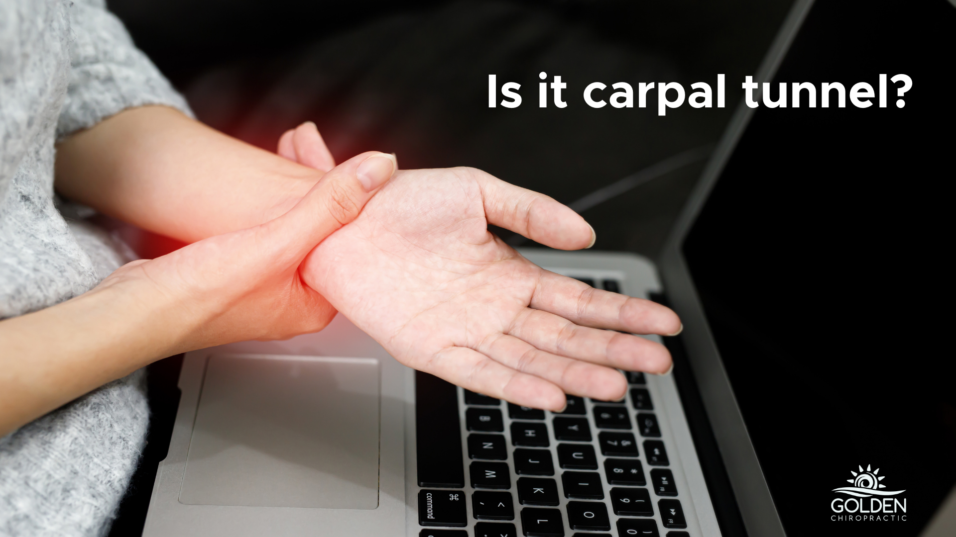 woman's hand gripping the wrist of her other hand in front of a laptop keyboard