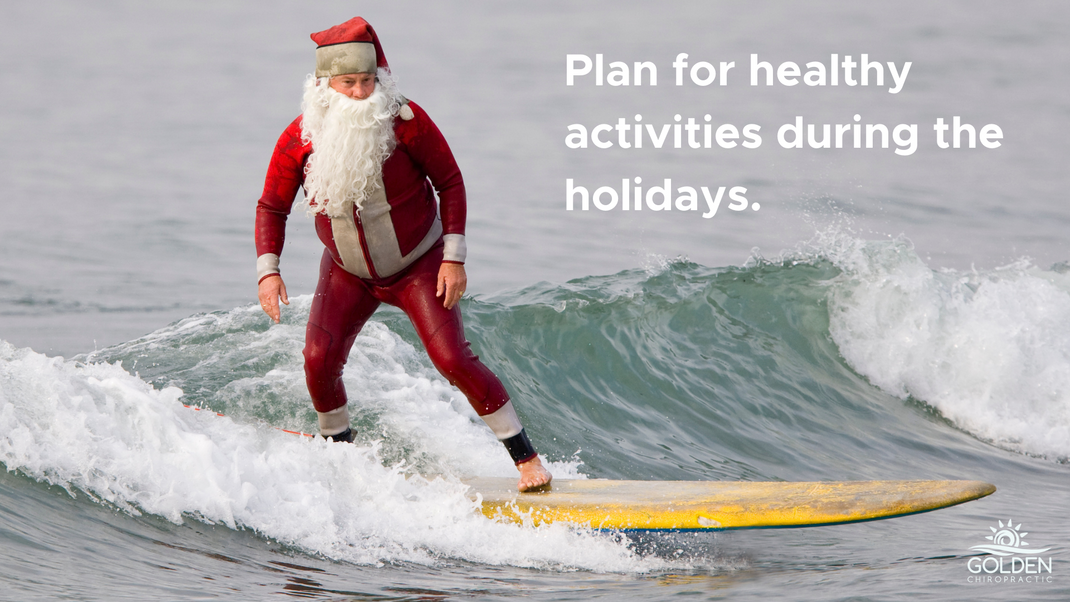 santa surfing a wave on a longboard