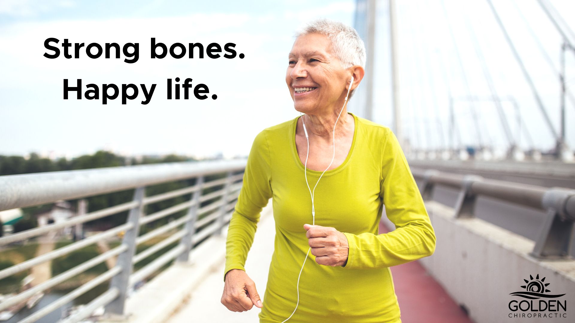older woman smiling while power walking over a bridge