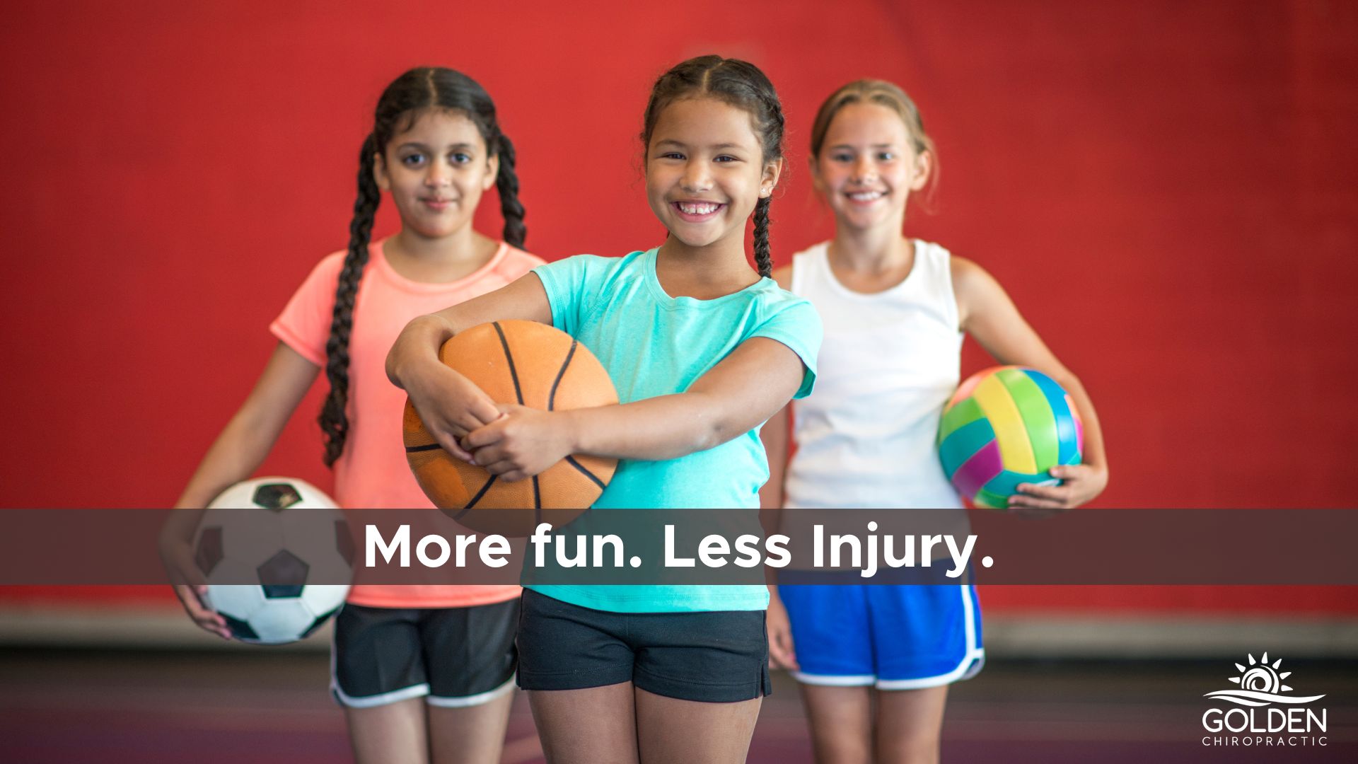 three girls holding balls wearing athletic clothes and smiling