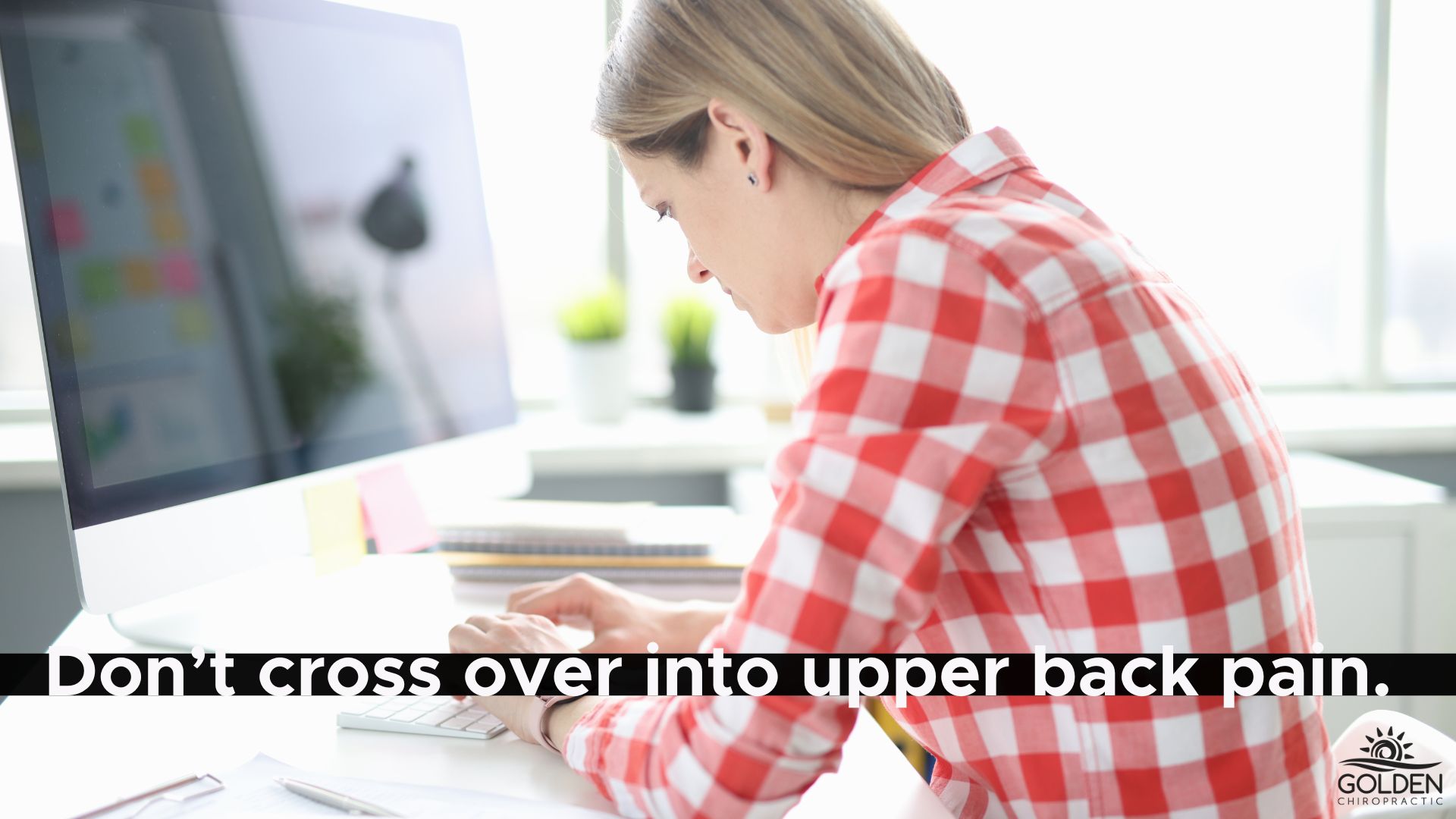 Woman hunched over her keyboard